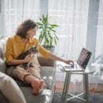Woman with cat and laptop
