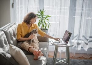 Woman with cat and laptop