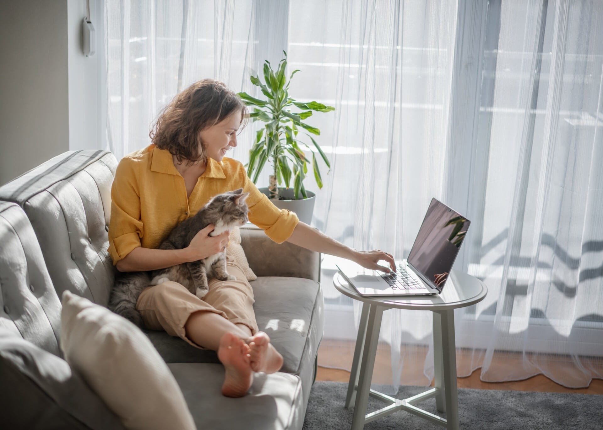 Woman with cat and laptop